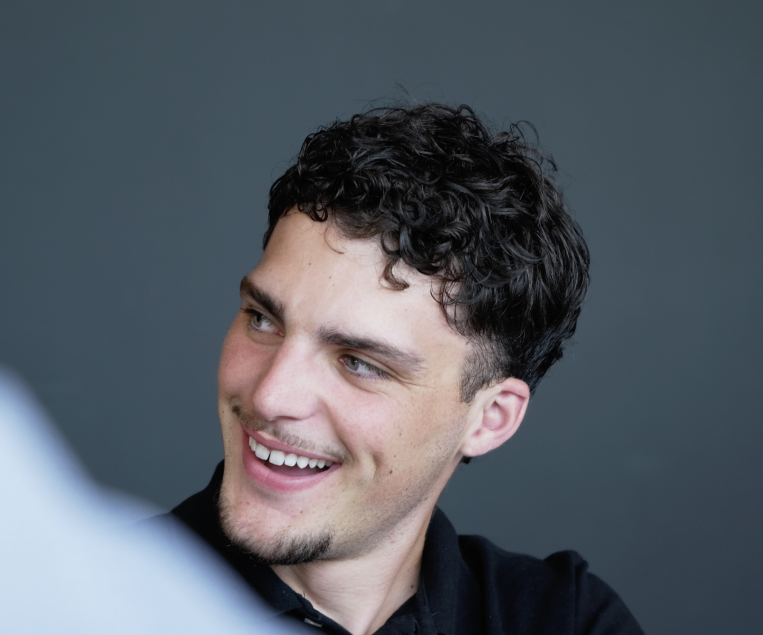 Portrait d'un membre souriant en polo noir