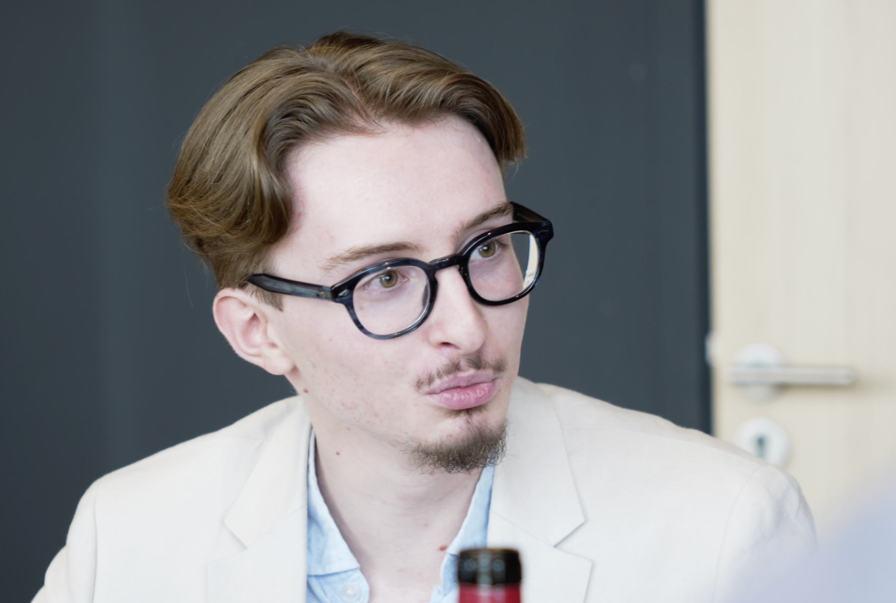 Portrait d'un membre en blazer clair avec lunettes